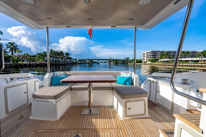 Slide: The Image of Azimut Fly 50 yacht deck with seating, overlooking serene waterfront view. - 40