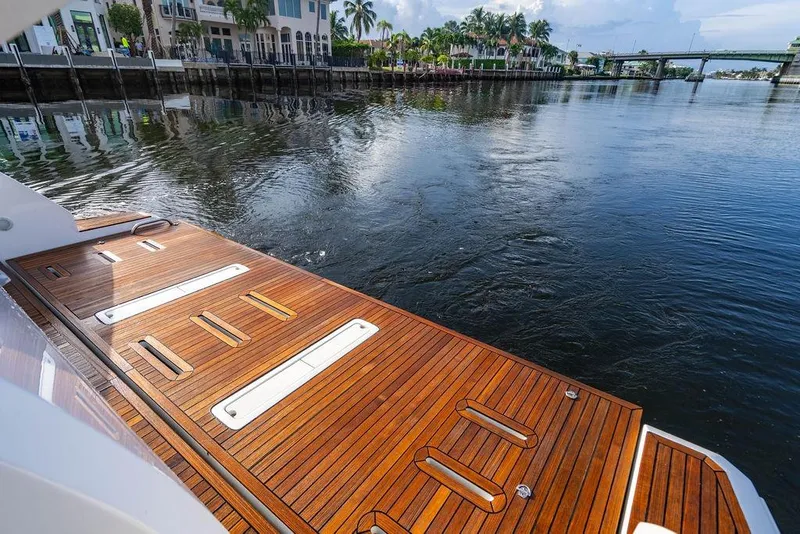 Slide: The Image of Luxurious 2015 Azimut Fly 50 yacht with elegant wooden deck by the water. - 42