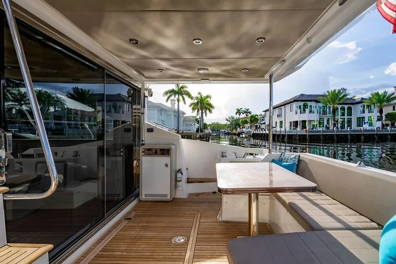 Slide: The Image of Luxurious 2015 Azimut Fly 50 yacht deck with seating, table, and waterfront view. - 48