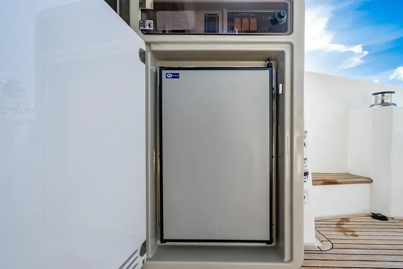 Slide: The Image of Refrigerator on 2015 Azimut Fly 50 yacht, open door, wooden deck, blue sky. - 49