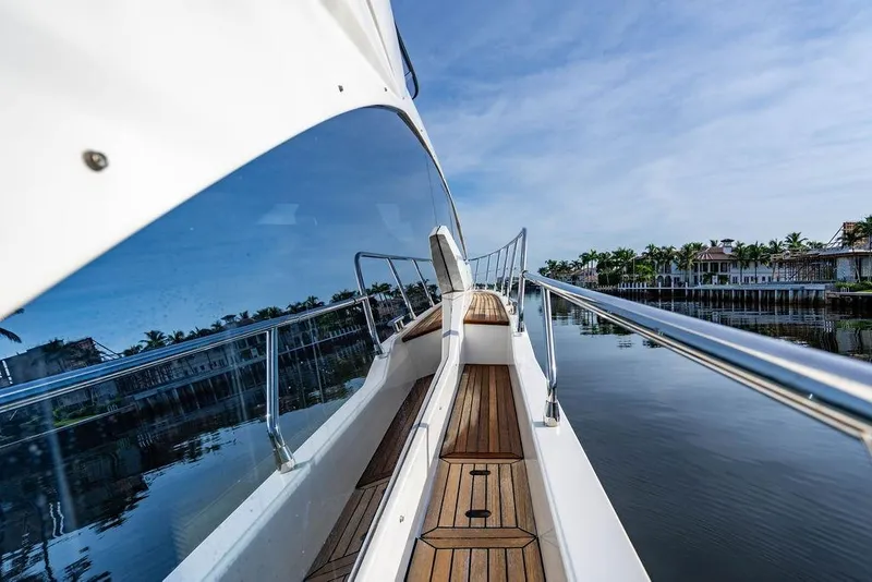 Slide: The Image of Azimut Fly 50 yacht deck view, 2015 model, reflecting calm waters and luxury homes. - 50