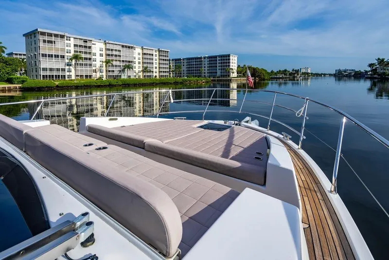 Slide: The Image of Luxurious 2015 Azimut Fly 50 yacht with spacious deck, docked near waterfront apartments. - 51