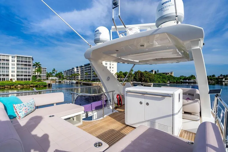 Slide: The Image of Luxurious 2015 Azimut Fly 50 yacht deck with modern seating and scenic waterfront view. - 59
