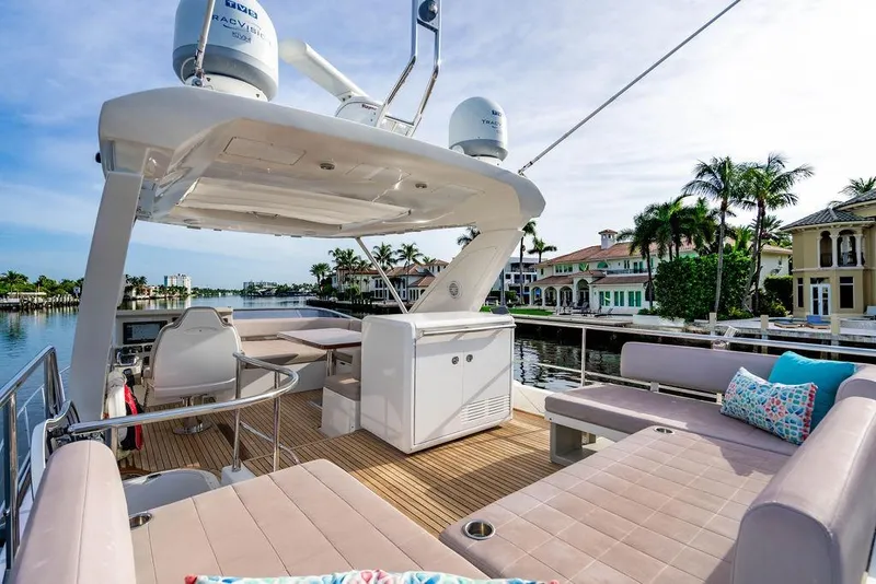 Slide: The Image of Luxurious 2015 Azimut Fly 50 yacht with spacious deck, elegant seating, and waterfront view. - 61