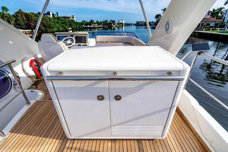 Slide: The Image of 2015 Azimut Fly 50 yacht deck with sleek cabinetry and scenic waterfront view. - 62