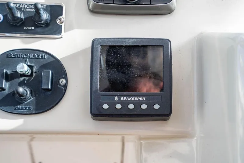 Slide: The Image of Control panel on 2015 Azimut Fly 50 yacht featuring Seakeeper and searchlight controls. - 75