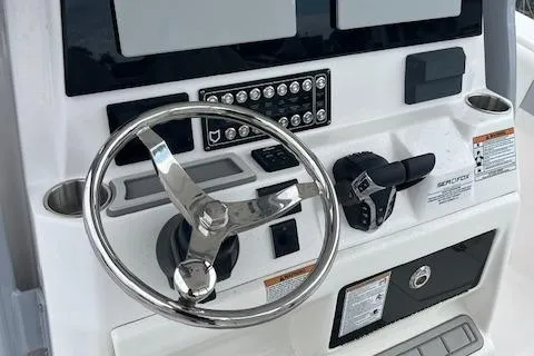 Slide: The Image of 2025 Sea Fox 288 Commander boat dashboard with steering wheel and controls. - 11