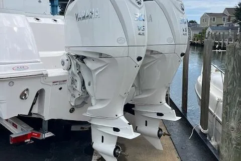 Slide: The Image of 2025 Sea Fox 288 Commander with twin Yamaha outboard engines docked by the water. - 3