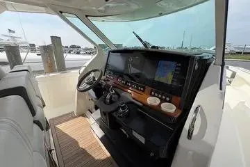 Slide: The Image of 2021 Tiara Yachts 38 LS helm with modern navigation system and luxurious interior. - 13