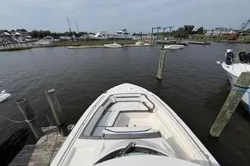 Slide: The Image of 2021 Tiara Yachts 38 LS docked in a marina, showcasing sleek design and spacious deck. - 16