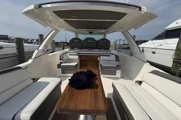 Slide: The Image of 2021 Tiara Yachts 38 LS interior with seating and table, docked at marina. - 18