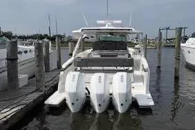 Slide: The Image of 2021 Tiara Yachts 38 LS with triple outboard engines docked at marina. - 20