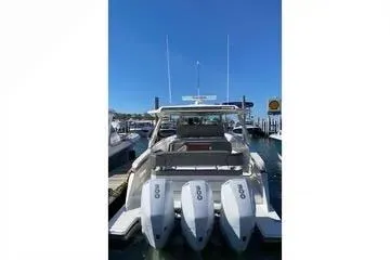 Slide: The Image of 2021 Tiara Yachts 38 LS with triple outboard engines docked at marina. - 4