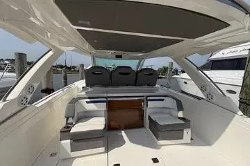 Slide: The Image of 2021 Tiara Yachts 38 LS interior with seating and helm, docked at marina. - 5