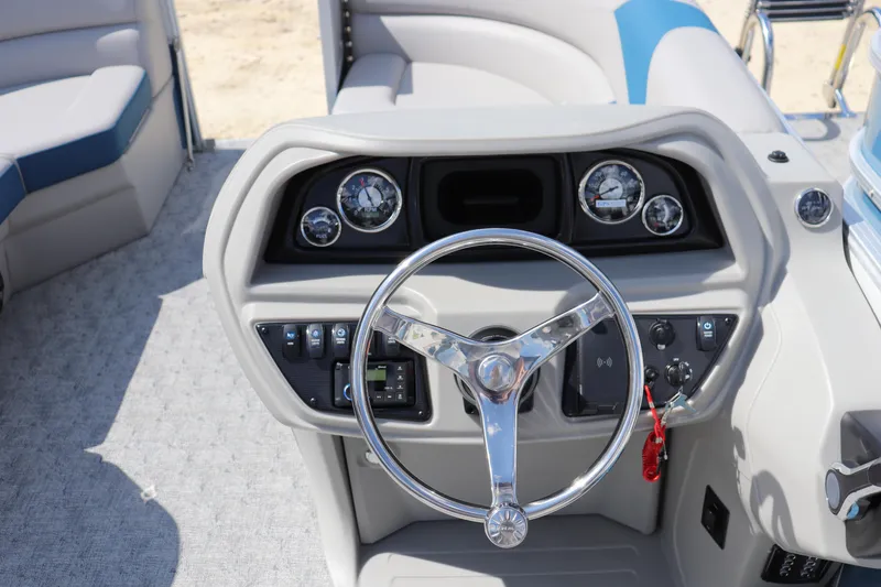 Slide: The Image of 2025 Trifecta 22 RF LE 2.75 boat dashboard with steering wheel and control panel. - 8