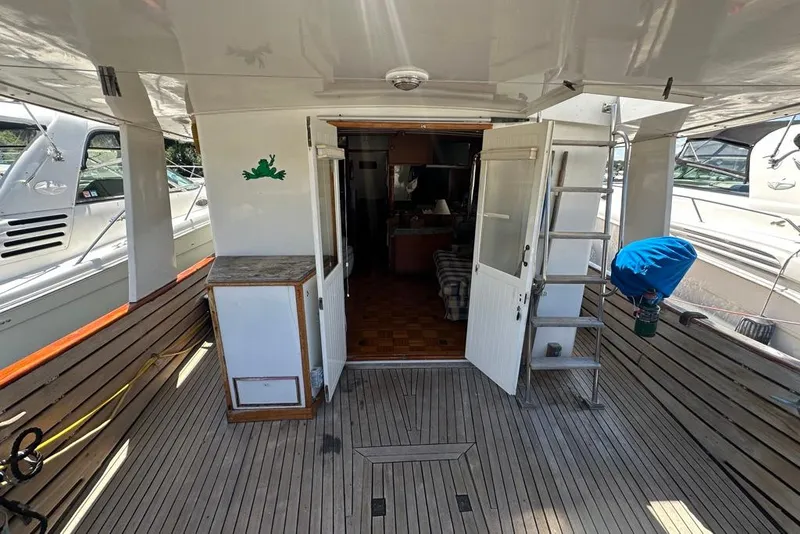 Slide: The Image of 1983 Kadey-Krogen Krogen 42 Trawler deck with wooden flooring and open cabin doors. - 4