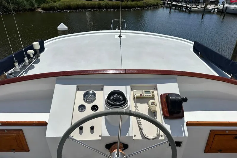 Slide: The Image of 1983 Kadey-Krogen Krogen 42 Trawler helm with steering wheel and navigation controls. - 10