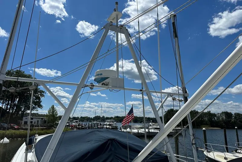 Slide: The Image of 1983 Kadey-Krogen Krogen 42 Trawler mast and radar against blue sky with clouds. - 12