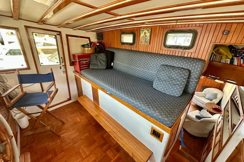Slide: The Image of 1983 Kadey-Krogen Krogen 42 Trawler interior with cozy seating and wooden accents. - 16