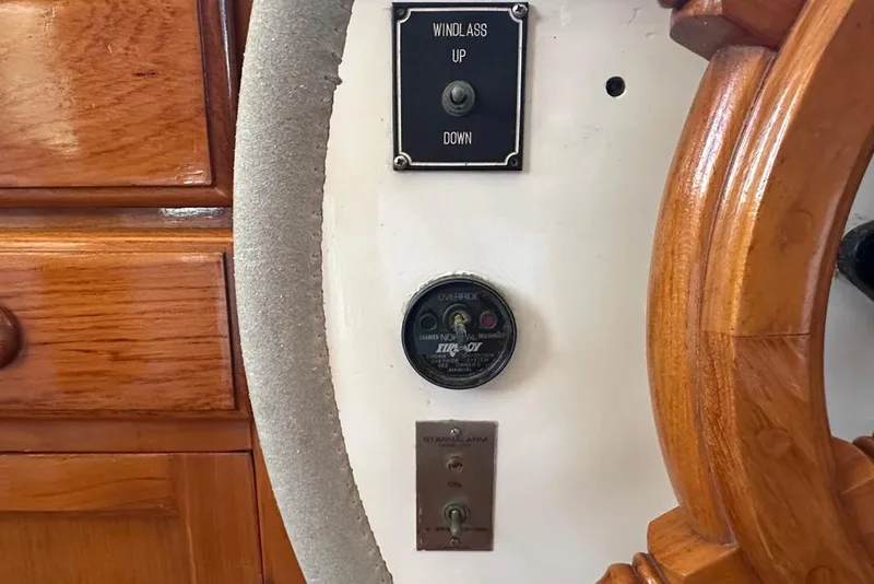 Slide: The Image of 1983 Kadey-Krogen Krogen 42 Trawler helm with windlass controls and wooden wheel. - 17