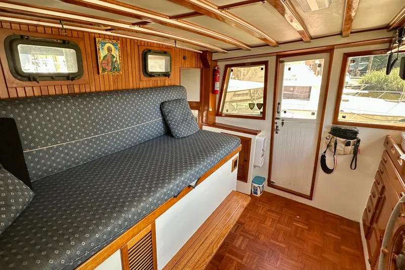 Slide: The Image of Interior of 1983 Kadey-Krogen Krogen 42 Trawler with wooden accents and cushioned seating. - 20