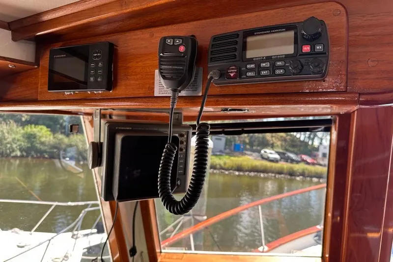 Slide: The Image of 1983 Kadey-Krogen Krogen 42 Trawler interior with navigation equipment and radio controls. - 21