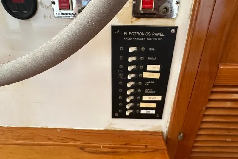 Slide: The Image of Electronics panel of 1983 Kadey-Krogen Krogen 42 Trawler with labeled switches. - 24