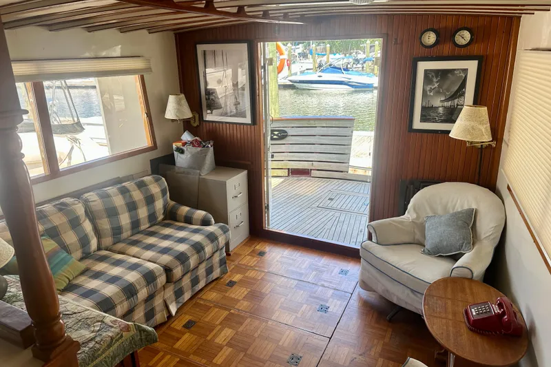 Slide: The Image of Cozy 1983 Kadey-Krogen Krogen 42 Trawler interior with plaid sofa and waterfront view. - 26