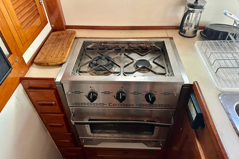 Slide: The Image of Galley stove in 1983 Kadey-Krogen Krogen 42 Trawler, featuring wooden cabinetry and countertop. - 28