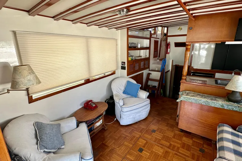 Slide: The Image of Interior of 1983 Kadey-Krogen Krogen 42 Trawler with cozy seating and wooden accents. - 32