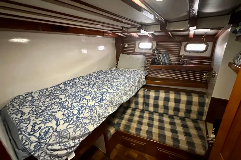 Slide: The Image of Cozy cabin interior of 1983 Kadey-Krogen Krogen 42 Trawler with nautical bedding and plaid seating. - 34
