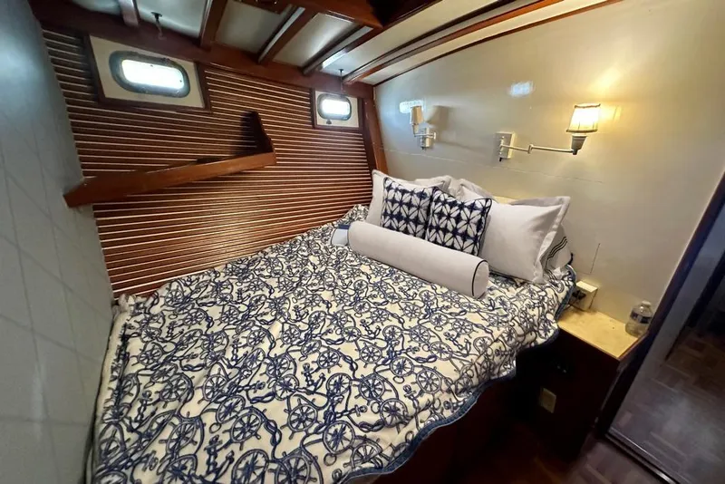 Slide: The Image of Cozy cabin interior of 1983 Kadey-Krogen Krogen 42 Trawler with nautical bedding and warm lighting. - 36