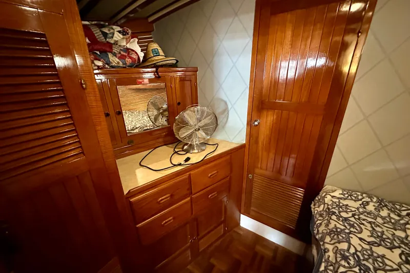 Slide: The Image of 1983 Kadey-Krogen Krogen 42 Trawler cabin with wooden cabinetry and fan. - 37