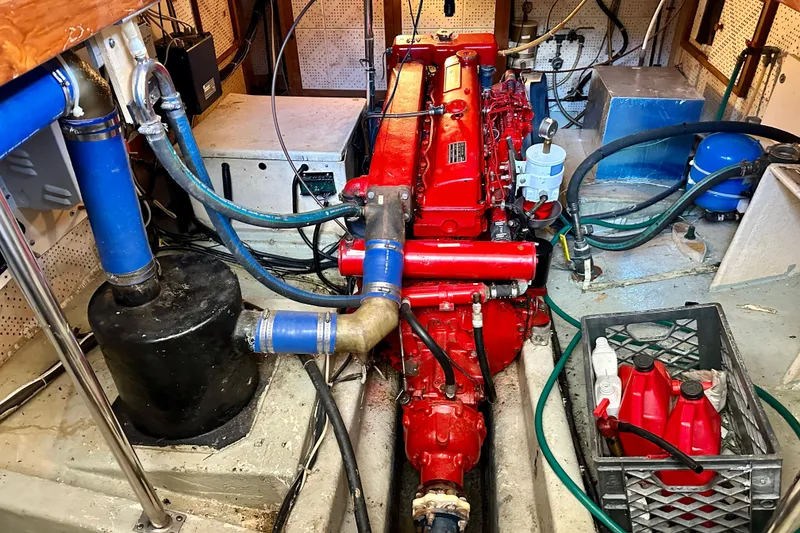 Slide: The Image of Engine room of 1983 Kadey-Krogen Krogen 42 Trawler with red engine and blue hoses. - 39