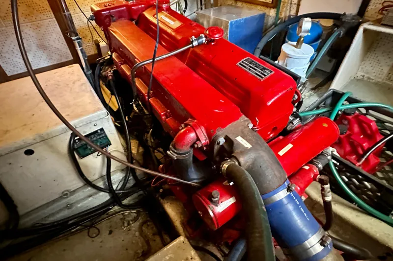 Slide: The Image of Engine room of 1983 Kadey-Krogen Krogen 42 Trawler with red machinery and hoses. - 40