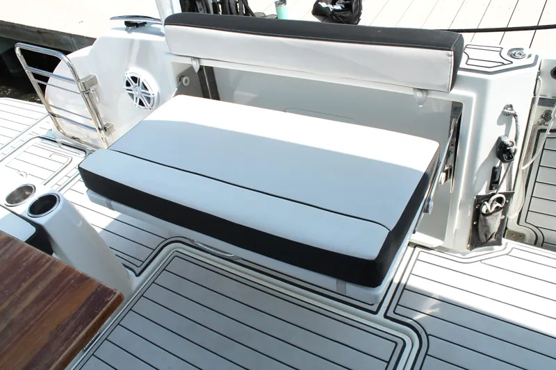 Slide: The Image of 2021 Jeanneau Leader 10.5 boat seating area with white cushions and sleek design. - 17