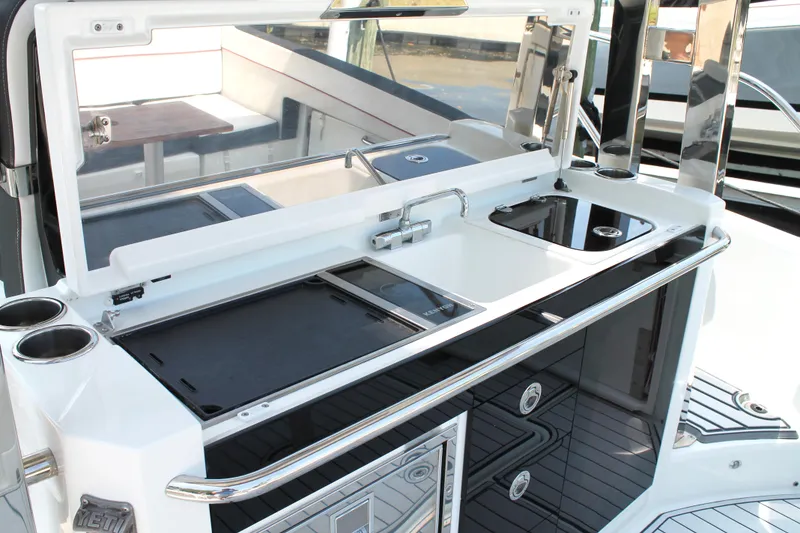 Slide: The Image of 2021 Jeanneau Leader 10.5 boat kitchen area with sink and storage compartments. - 19