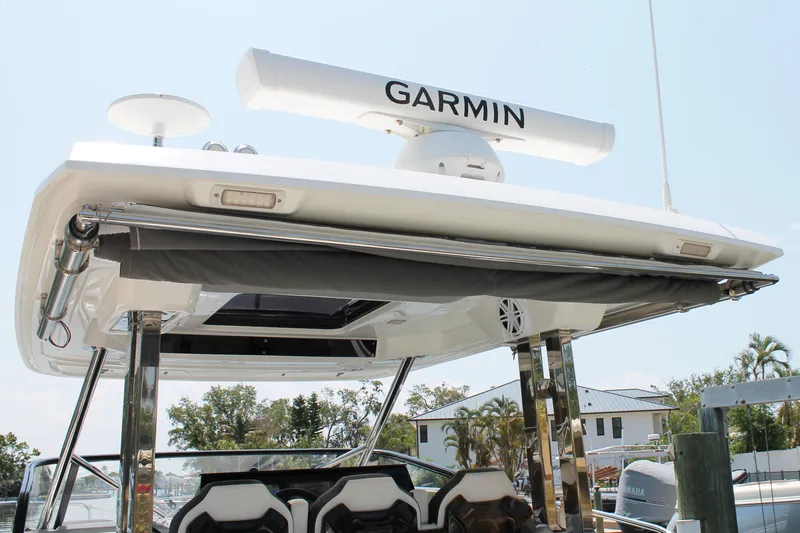 Slide: The Image of 2021 Jeanneau Leader 10.5 boat with Garmin radar, docked in a marina. - 25