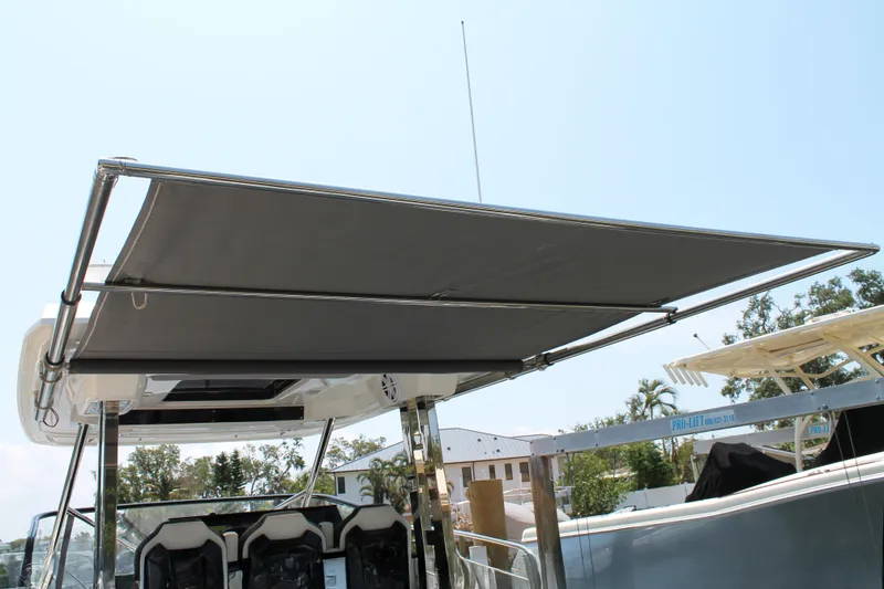 Slide: The Image of 2021 Jeanneau Leader 10.5 boat with sunshade canopy, showcasing sleek design and comfort. - 26