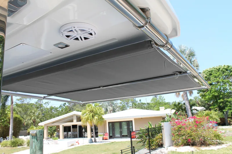 Slide: The Image of 2021 Jeanneau Leader 10.5 boat awning, providing shade in a sunny residential setting. - 27