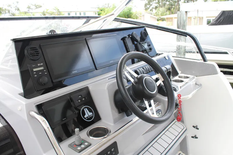 Slide: The Image of 2021 Jeanneau Leader 10.5 WA Series 2 helm with modern navigation displays and controls. - 33