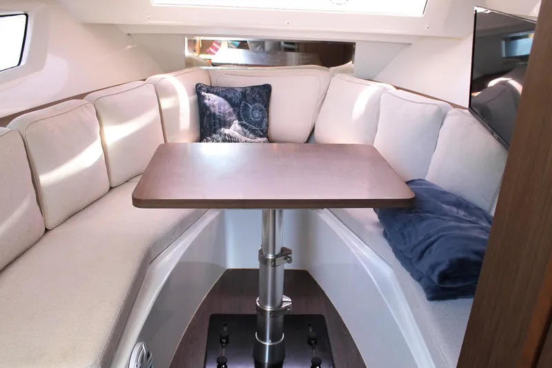 Slide: The Image of Cozy interior of 2021 Jeanneau Leader 10.5 with cushioned seating and table. - 39