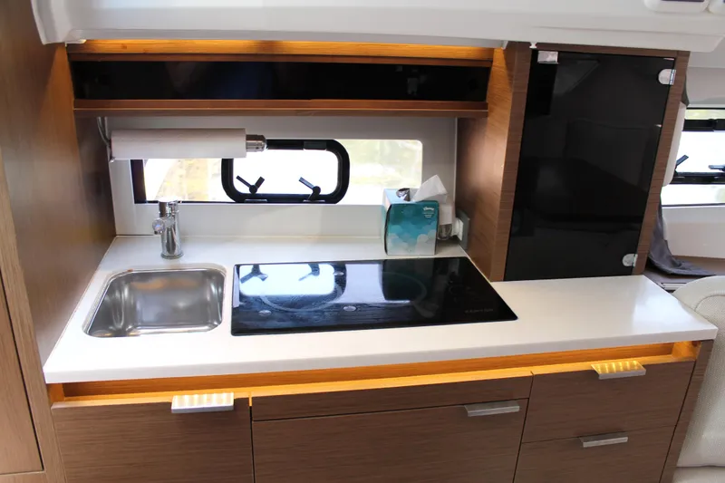 Slide: The Image of 2021 Jeanneau Leader 10.5 yacht kitchen with sink, stove, and storage cabinets. - 41