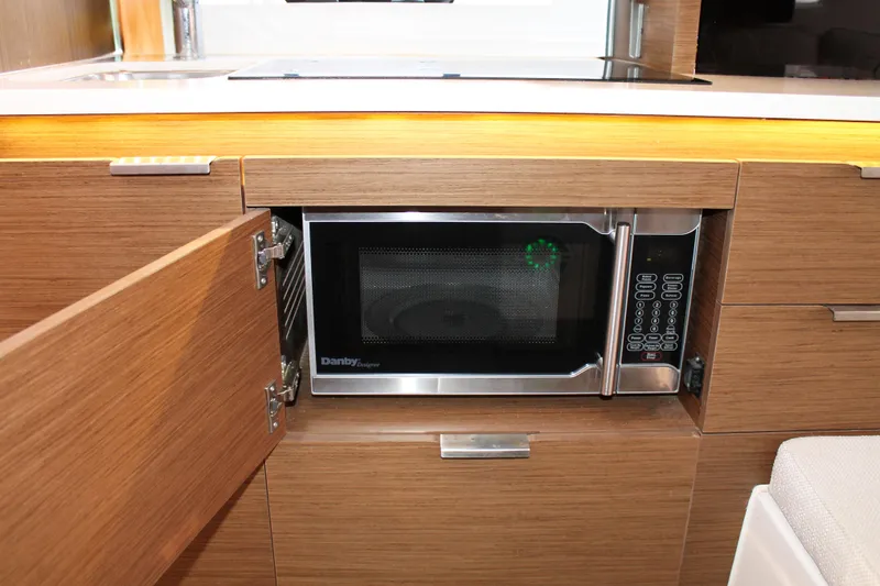 Slide: The Image of Modern kitchen area in 2021 Jeanneau Leader 10.5 with built-in microwave. - 42