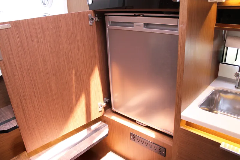 Slide: The Image of 2021 Jeanneau Leader 10.5 interior with compact fridge and sink. - 43