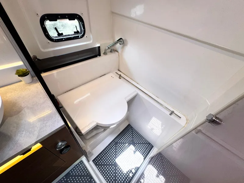 Slide: The Image of 2021 Jeanneau Leader 10.5 boat bathroom with compact shower and window. - 47