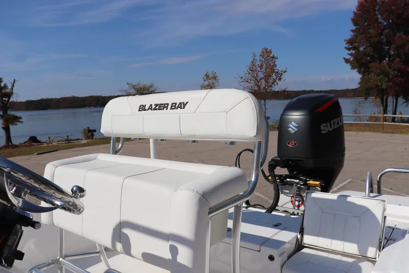 Slide: The Image of 2024 Blazer Bay 2220 Fisherman boat with Suzuki outboard motor by a scenic lake. - 11