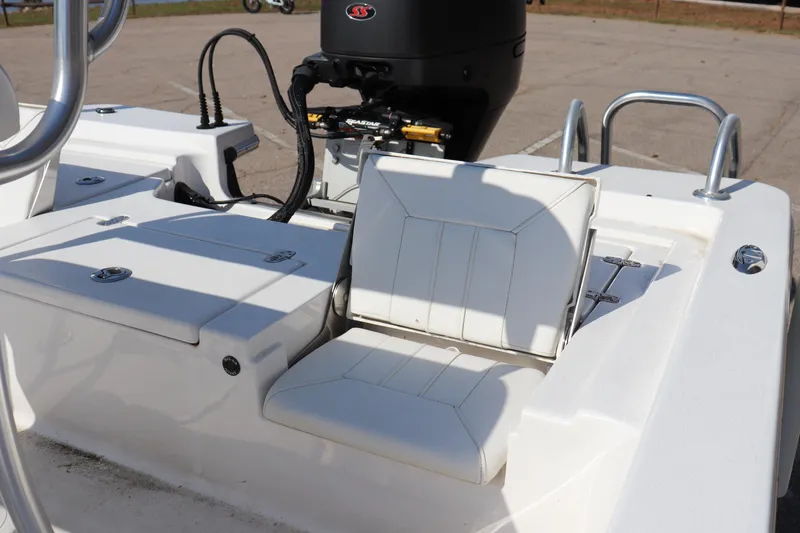 Slide: The Image of 2024 Blazer Bay 2220 Fisherman boat interior with white seating and motor detail. - 12