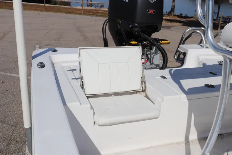 Slide: The Image of 2024 Blazer Bay 2220 Fisherman boat with white seating and motor, docked outdoors. - 13
