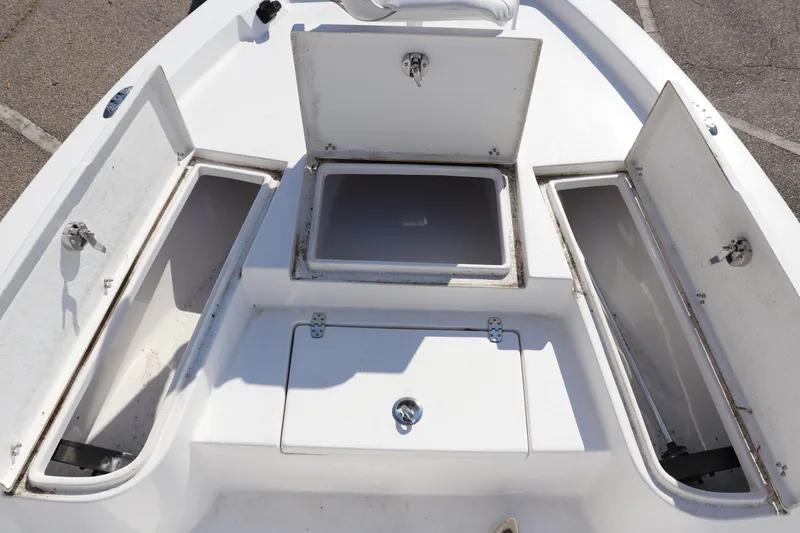Slide: The Image of 2024 Blazer Bay 2220 Fisherman boat storage compartments open on deck. - 3